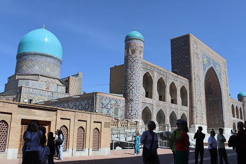 Intricate facade of the Tilya-Kori Madrasah on the Registan in Samarkand under a deep blue sky