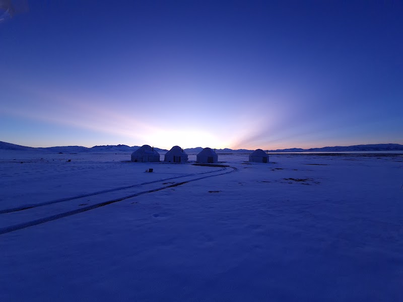 Yurt camp silhouetted against deep blue twilight at Son-Kul Lake, Kyrgyzstan